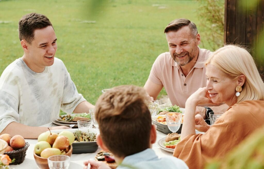 a family enjoying a nice dinner after using their outdoor kitchen in Reno